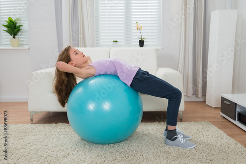 Girl Exercising On Pilates Ball