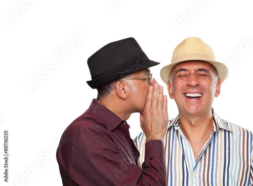 Close up of a man whispering to another man