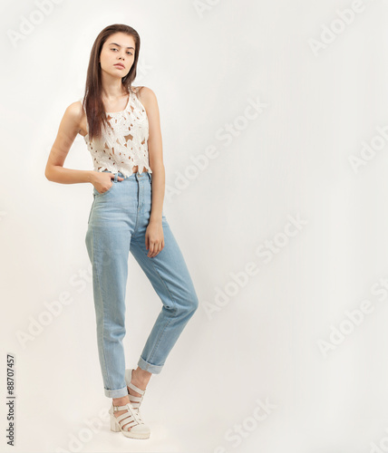 Full length portrait of young foxy beautiful brunette woman posing for model tests against white background