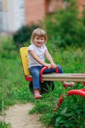 girl riding on a swing in the Playground