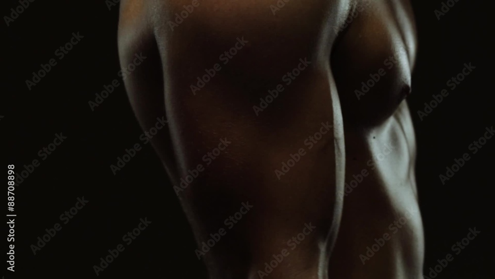 Young man showing work of muscles of body - biceps Young man showing work of muscles of body - biceps