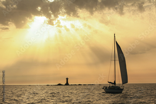 Sailing boats with a beautiful sunset at the sea photo