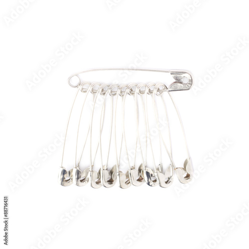 Bunch of safety pins isolated on white background