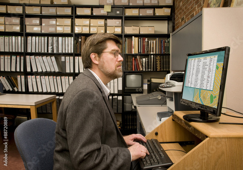 Researcher searching a computer database archive