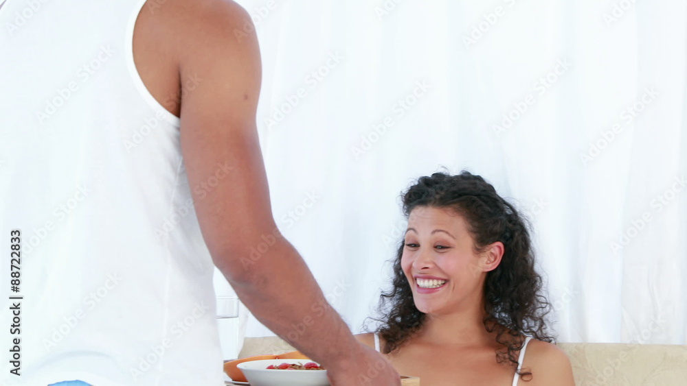 Husband bringing a breakfast tray to his pregnant wife Husband bringing a breakfast tray to his pregnant wife