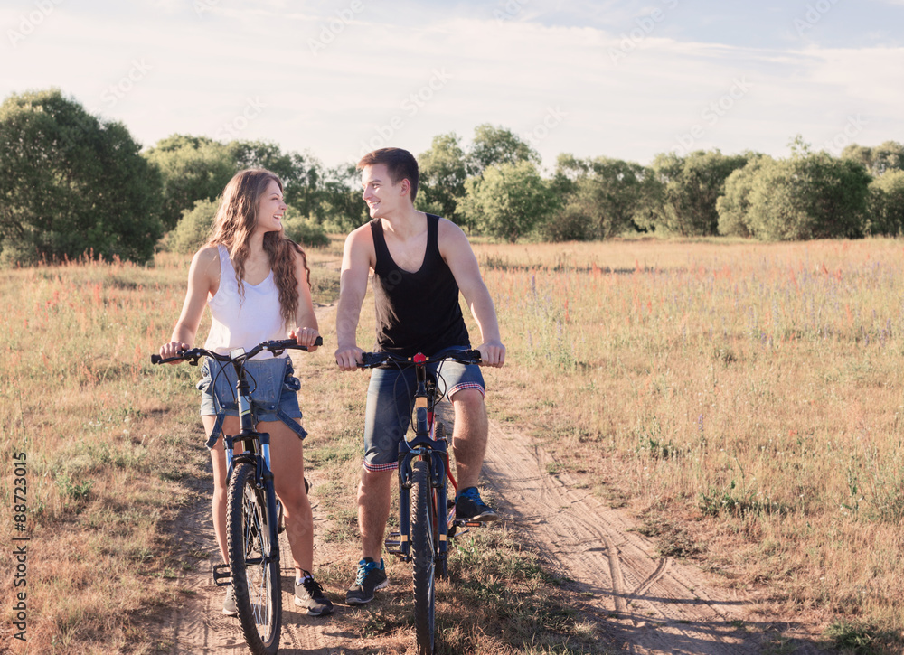 Fototapeta premium young couple having a bike ride in nature
