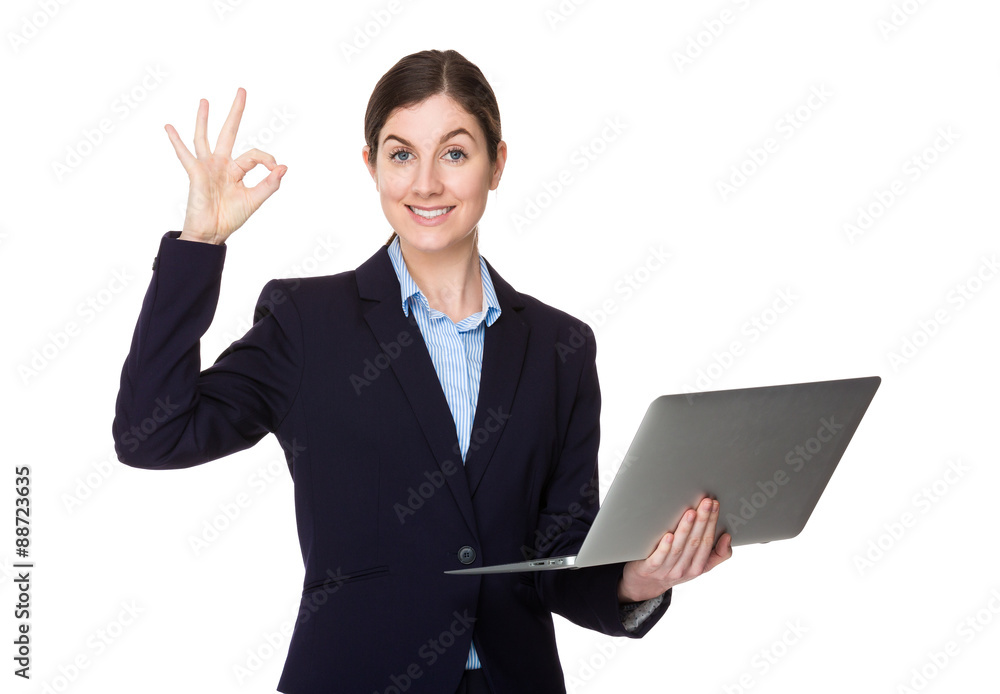 Businesswoman hold with laptop computer and ok sign gesture Businesswoman hold with laptop computer and ok sign gesture