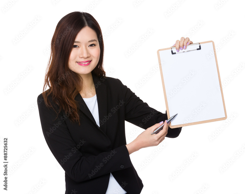 Asian businesswoman with pen point to white paper on clipboard Asian businesswoman with pen point to white paper on clipboard