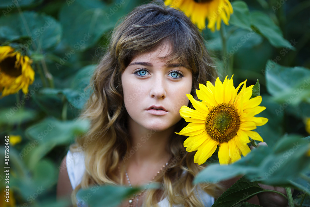Attractive young girl in the field of sunflowers Attractive young girl in the field of sunflowers
