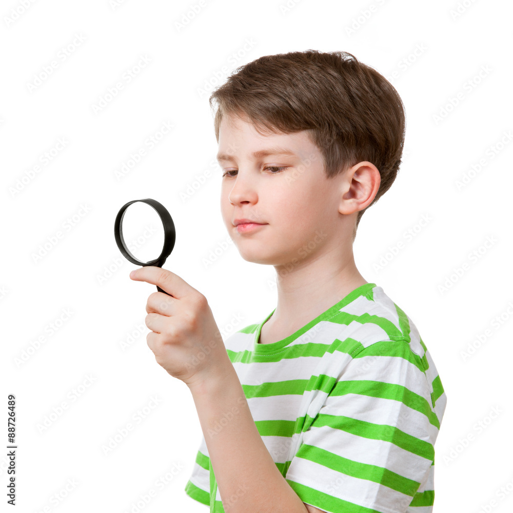 the boy looks through a magnifying glass the boy looks through a magnifying glass