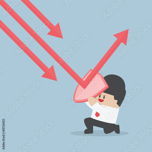 Businessman holding shield prevent from down trend graph to prot