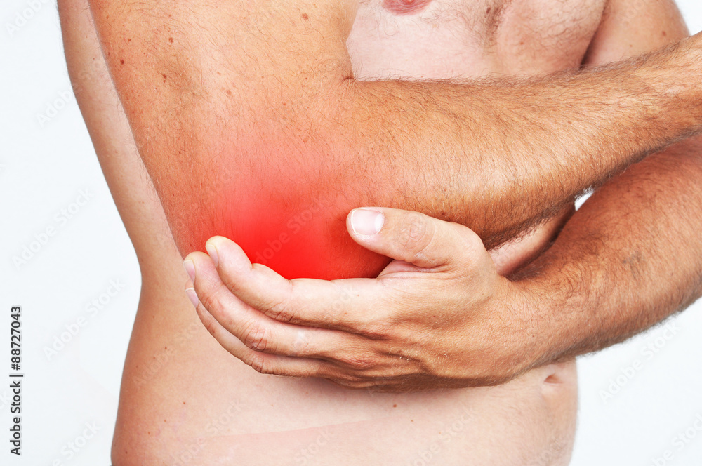 Man holding his elbow because of a pain. Man holding his elbow because of a pain.