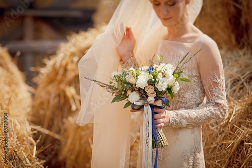The bride holds a beautiful wedding bouquet