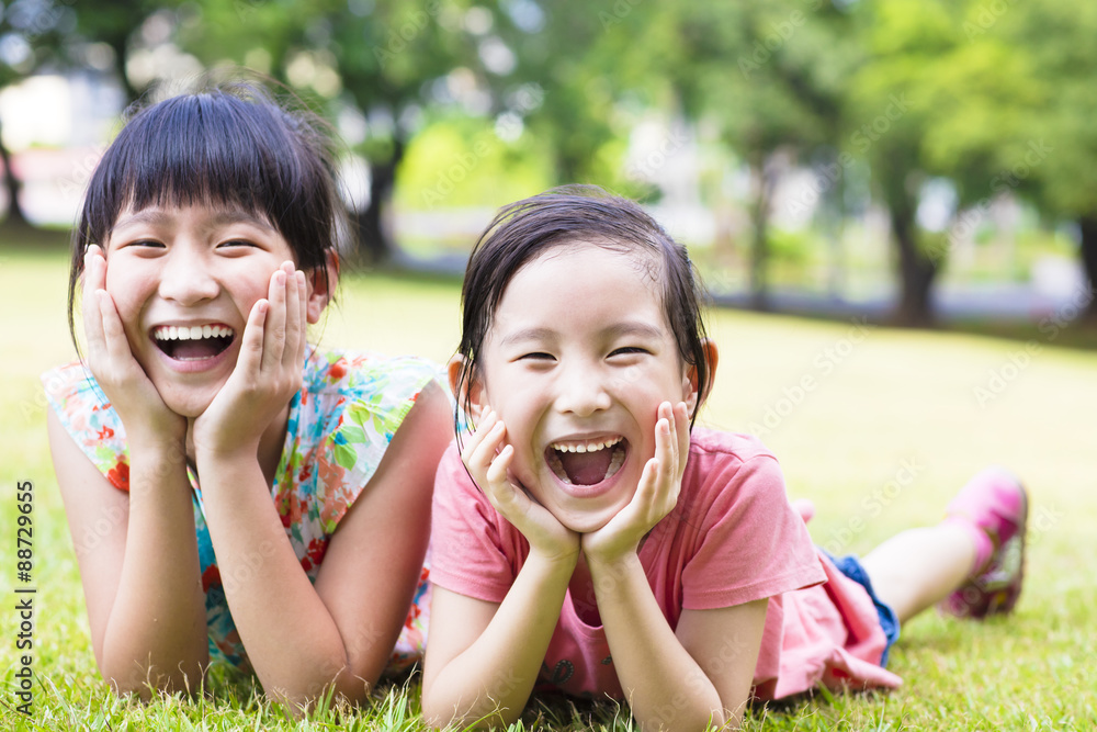 closeup happy little girls on the grass closeup happy little girls on the grass