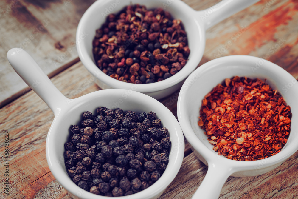 Bowls with dry pepper and paprika on wooden background Bowls with dry pepper and paprika on wooden background