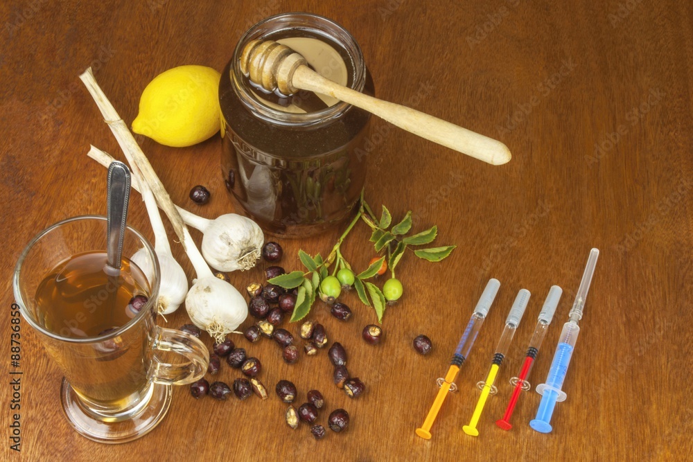 Fototapeta premium Rosehip tea and flu vaccination. Traditional medicine and modern treatment methods. Injection of influenza vaccine. Household treatment of flu and colds.