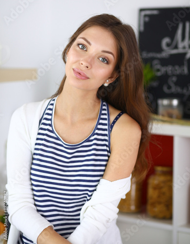 Young woman sitting in kitchen at home