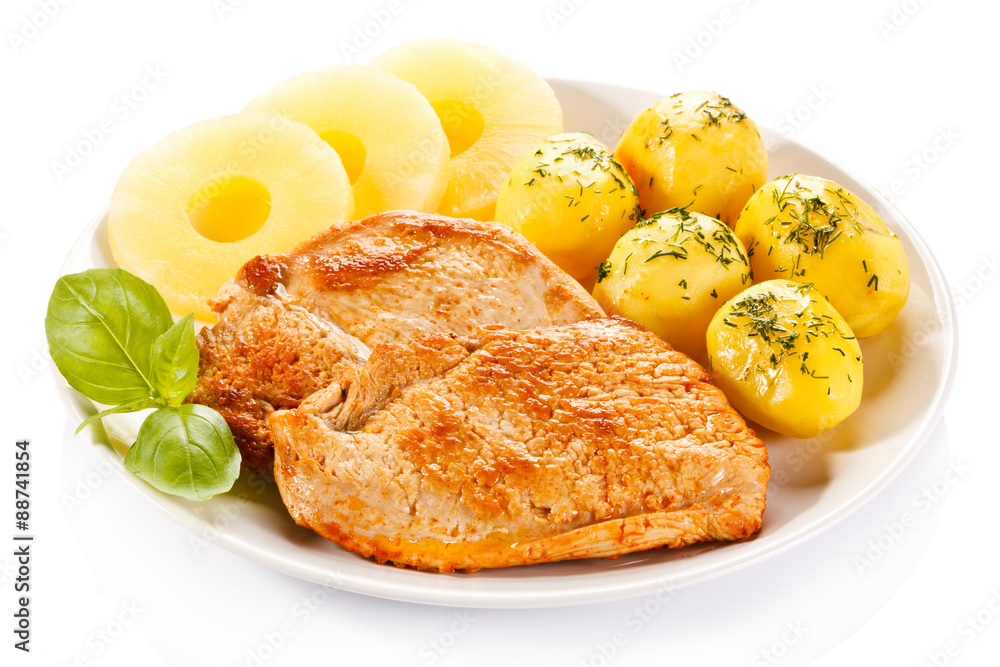 Fried chicken fillets, boiled potatoes and pineapples Fried chicken fillets, boiled potatoes and pineapples