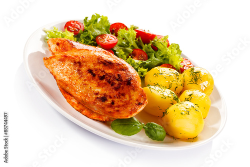 Fried chicken fillet, boiled potatoes and vegetable salad 