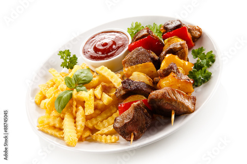 Grilled meat, French fries and vegetables 