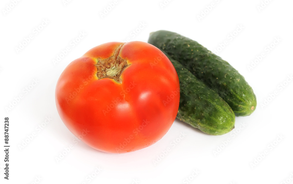 Tomato and two cucumber on white background Tomato and two cucumber on white background