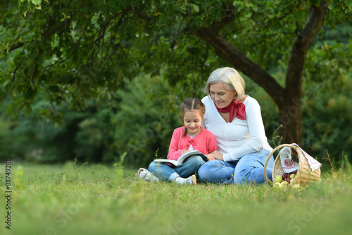 Little girl with grandmother and book