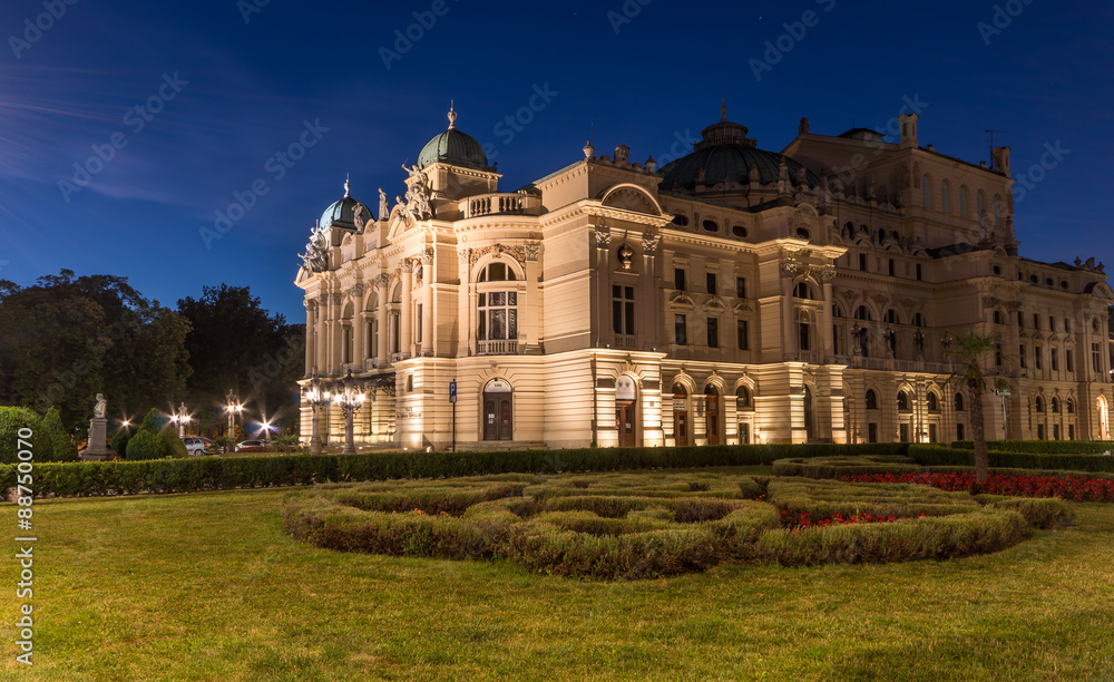 Juliusz Slowacki theatre in Krakow, Poland. Night view of illuminated XIXth century building, built in eclectic style.