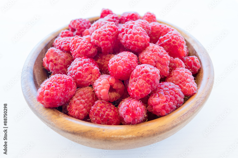 Fresh organic fruit - raspberry on wood background selective focus