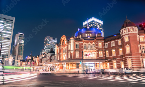 Traffic and people crossing the street outside the historic Tokyo Station, Tokyo