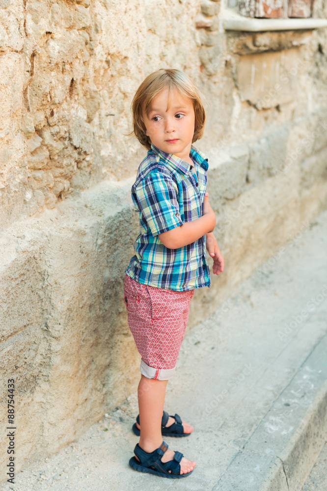 Fashion little boy wearing blue plaid shirt and red printed shorts Fashion little boy wearing blue plaid shirt and red printed shorts