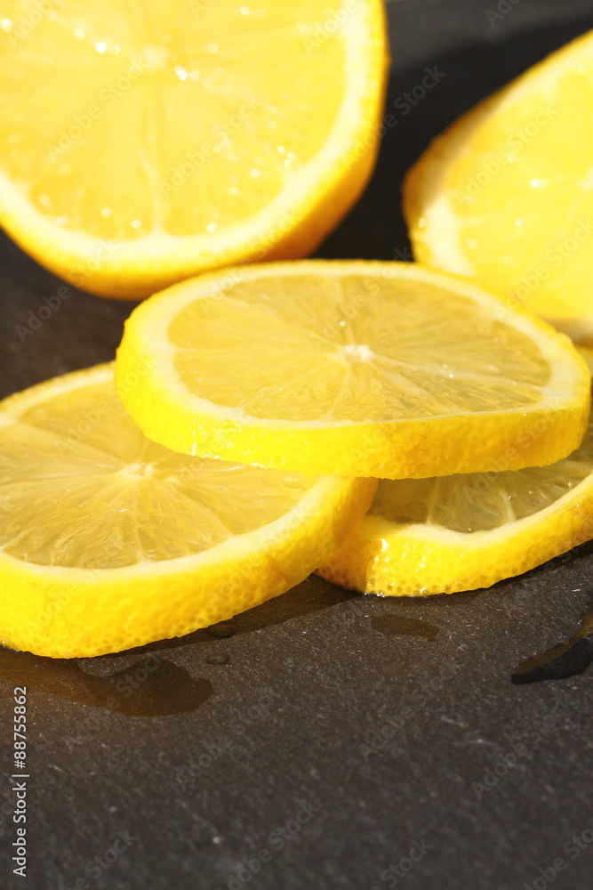 Lemon sliced slate.
Slices of lemon on a slate background. Lemon sliced slate.
Slices of lemon on a slate background.