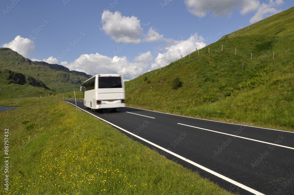 White bus on mountain road