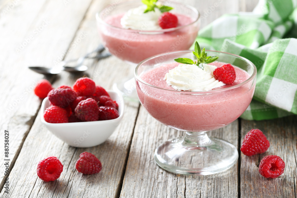 Sweet raspberry mousse in glass on grey wooden table Sweet raspberry mousse in glass on grey wooden table