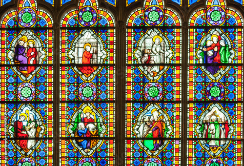 colorful stained glass window with saints.