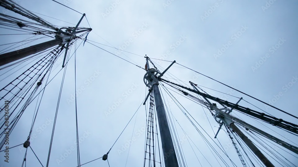Mainmast and masts of ancient sailboat against a stormy sky Mainmast and masts of ancient sailboat against a stormy sky