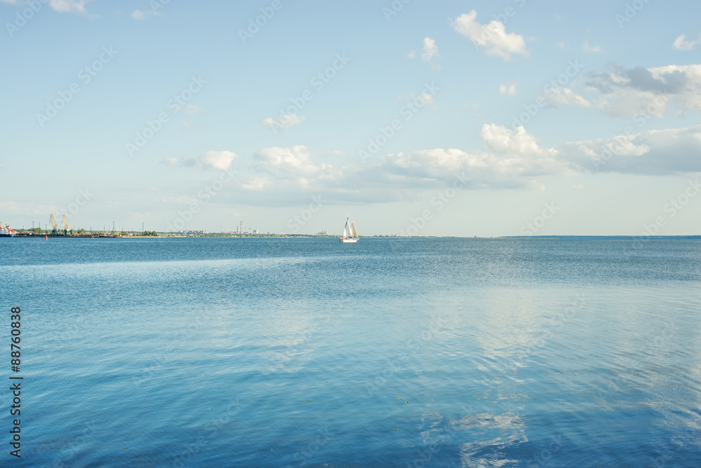 Obraz premium blue river and clouds on sunset with white yacht