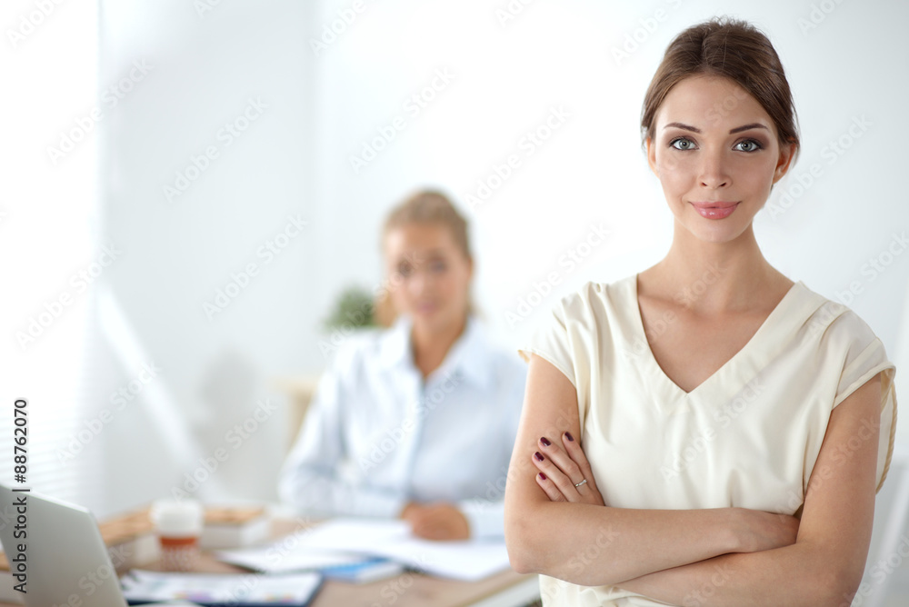 Attractive businesswoman standing near wall in office Attractive businesswoman standing near wall in office