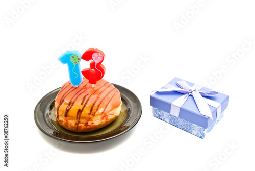 donut with thirteen years birthday candle and gift