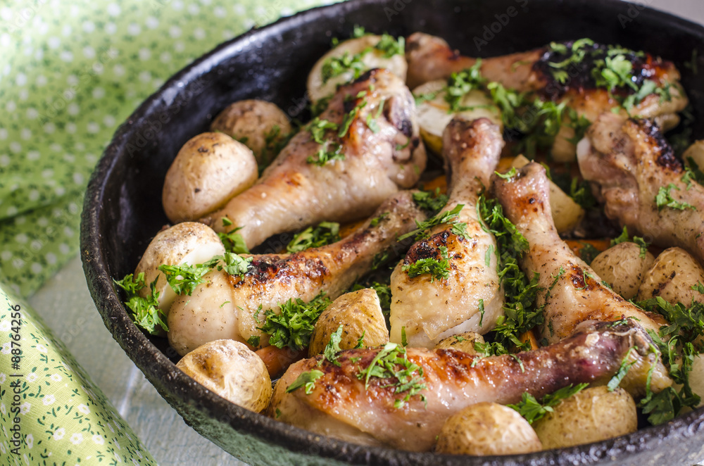 Crisp-tender chicken baked with roasted carrots and potatoes, shallow focus Crisp-tender chicken baked with roasted carrots and potatoes, shallow focus
