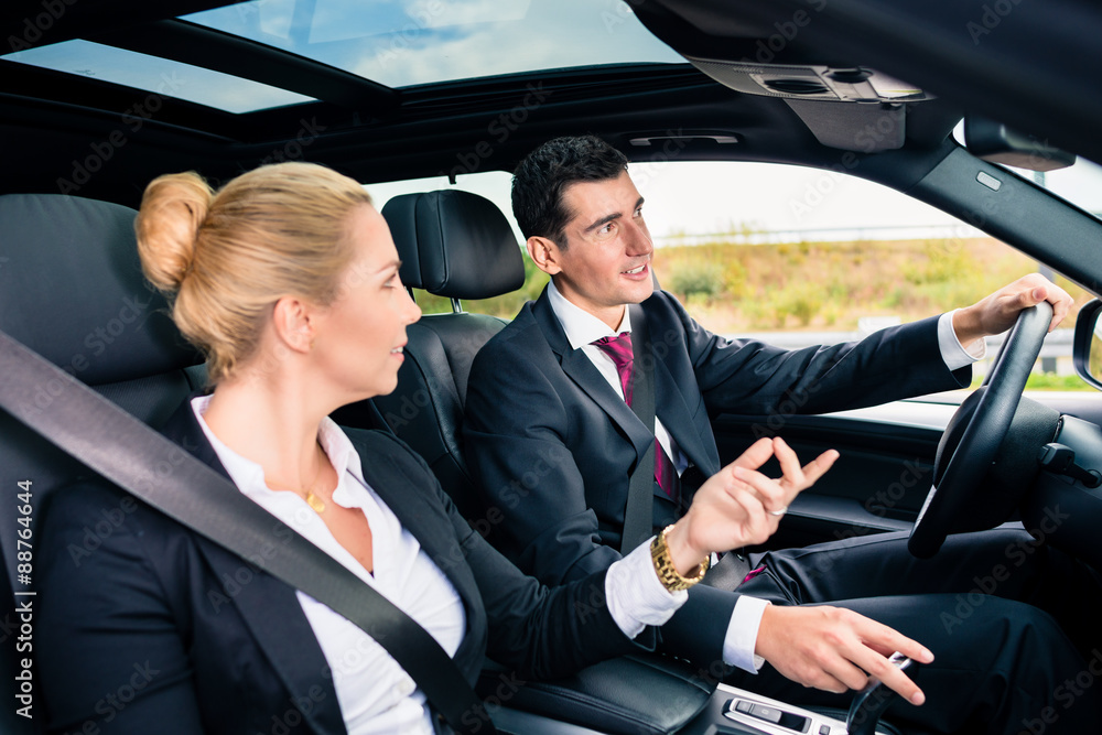Business couple in car travelling Business couple in car travelling