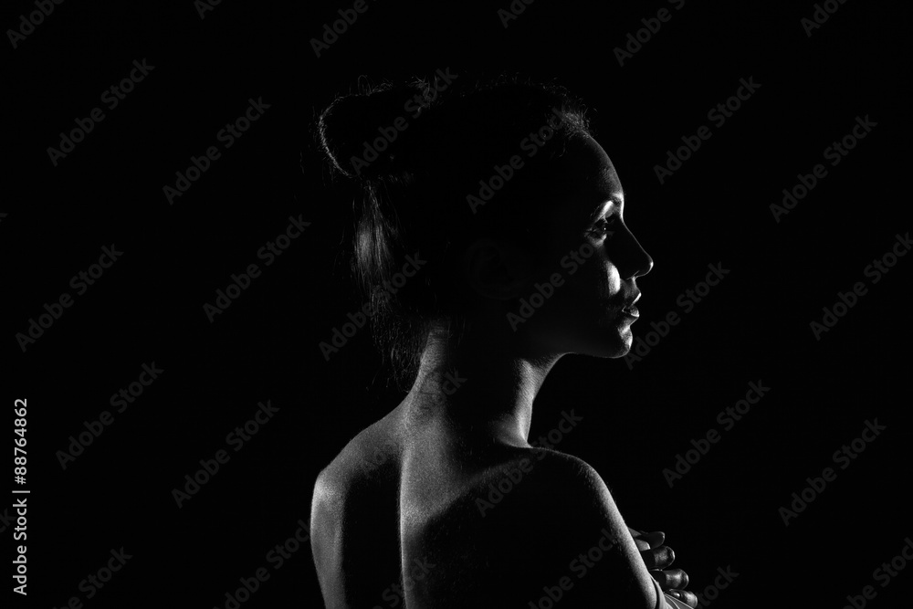 beautiful young woman in dark studio closeup