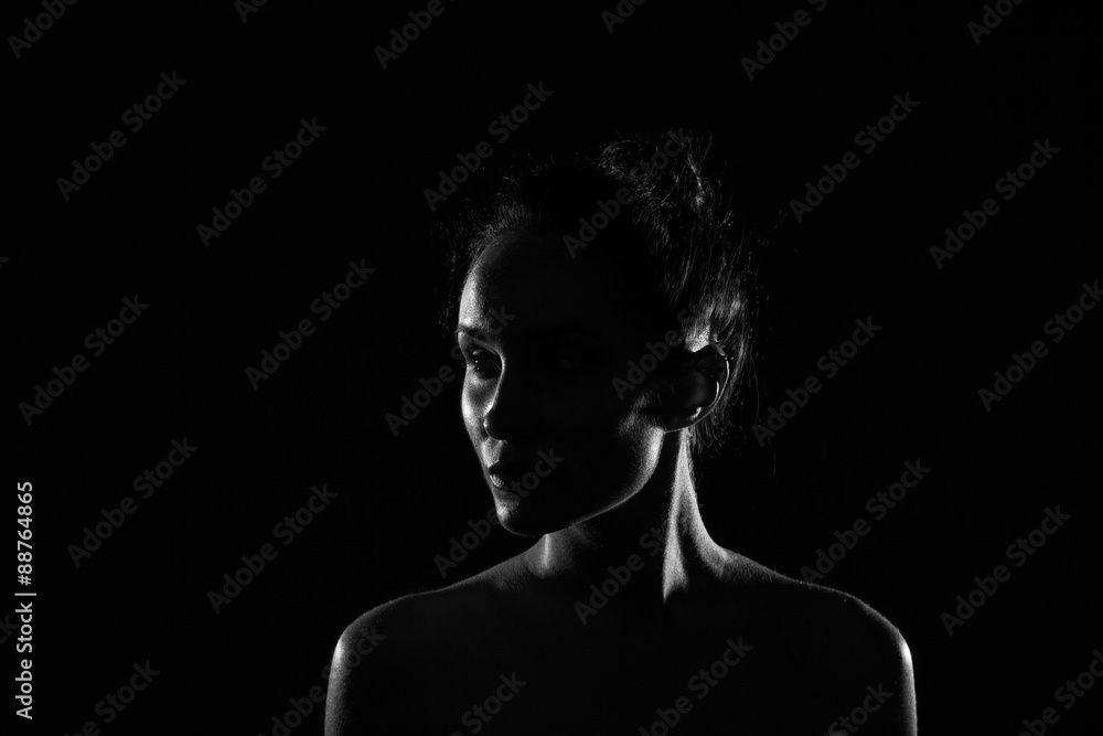 beautiful young woman in dark studio closeup beautiful young woman in dark studio closeup