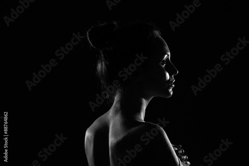 beautiful young woman in dark studio closeup