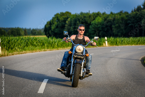 Tough guy on chopper bike in motion on the road © Manuel Findeis