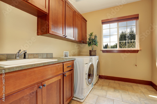 Typical laundry room with tile floor. © Iriana Shiyan