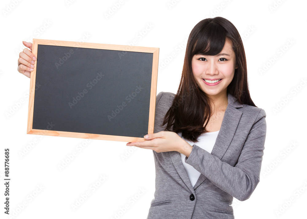 Young businesswoman showing the blank of chalkboard Young businesswoman showing the blank of chalkboard