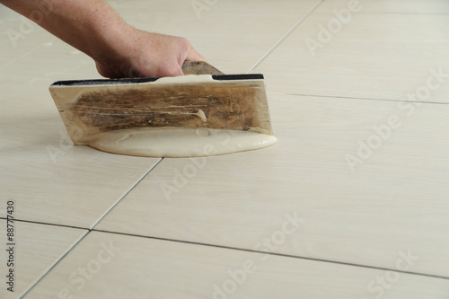 Fill the tile joints with grout photo