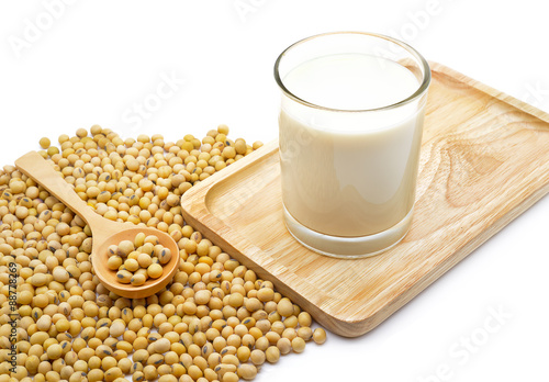Isolated soy beans and soy milk in a glass on wooden tray