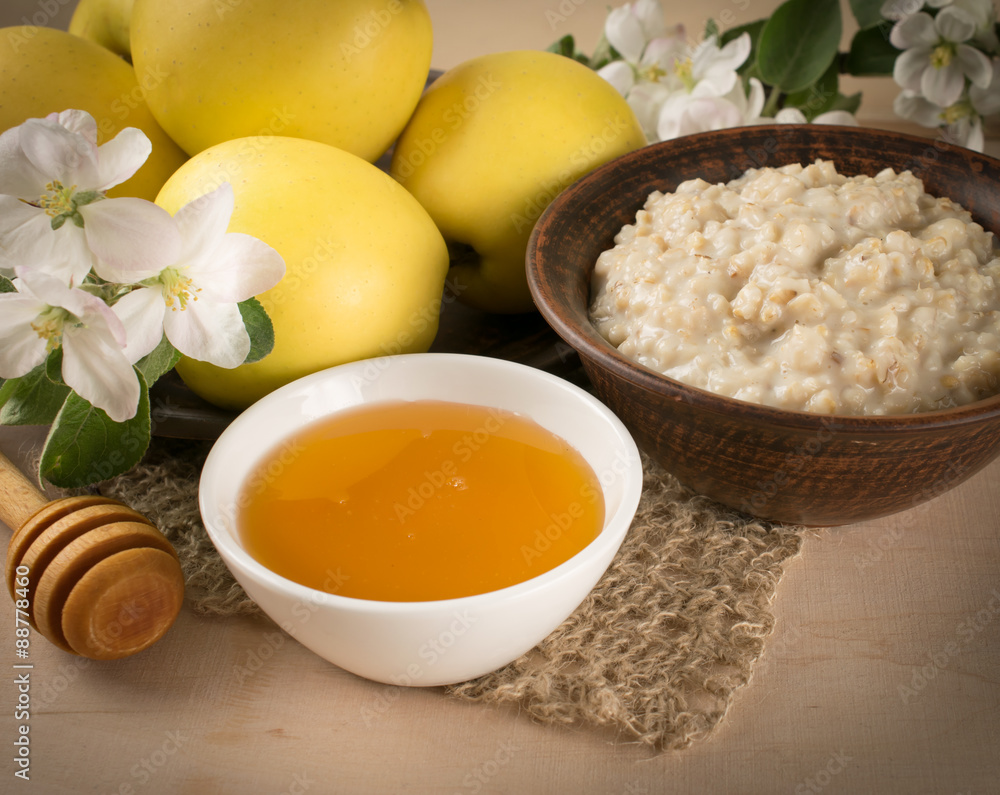 Yellow apples with oatmeal and honey, twig of apple tree Yellow apples with oatmeal and honey, twig of apple tree