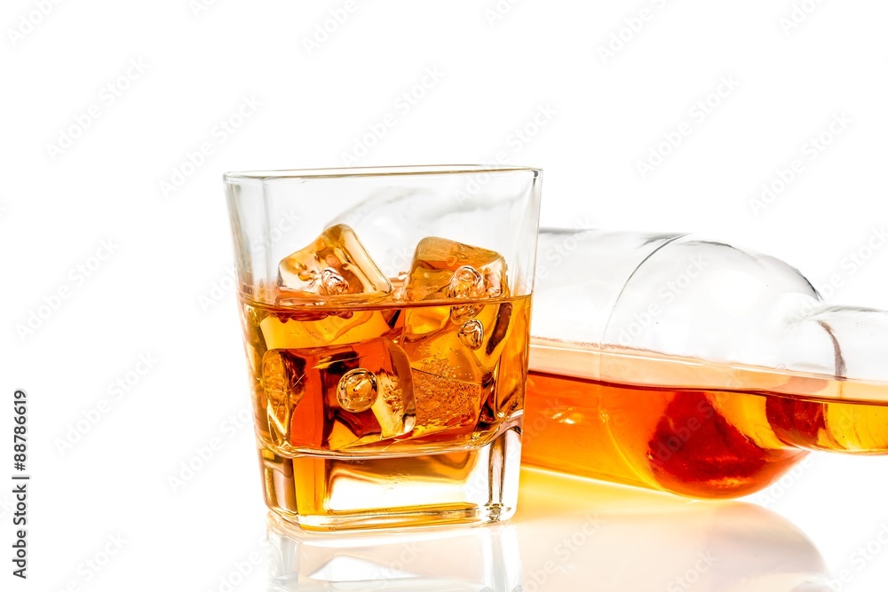 whiskey near bottle on white background with reflection whiskey near bottle on white background with reflection